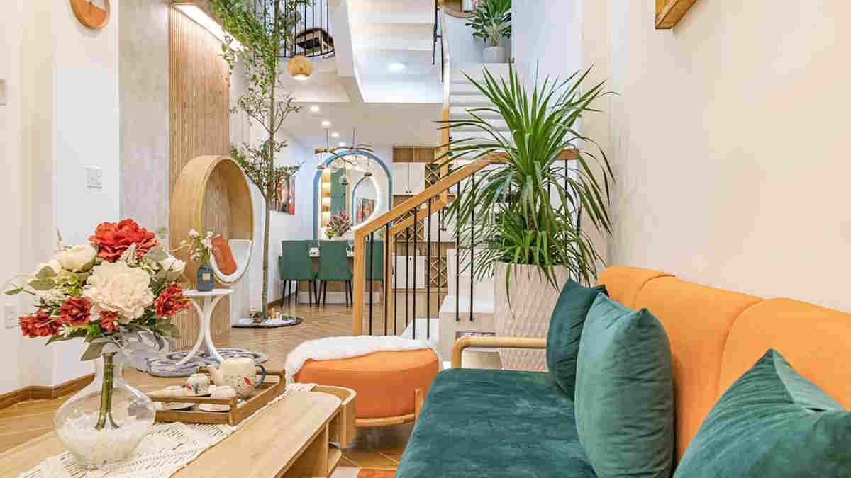 Salon moderne avec plantes, canapé coloré et décoration élégante.